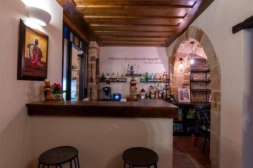 a bar in a room with two stools at Zacosta Villa Hotel in Rhodes Town