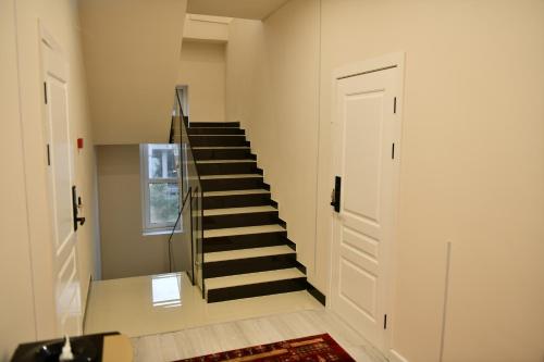 a staircase in a room with a stair case at QUT Hotel in Almaty