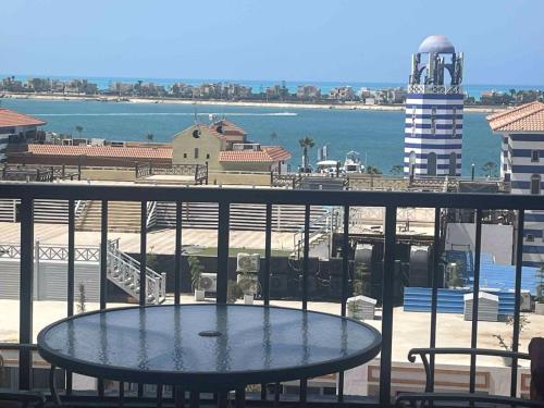 a table on a balcony with a view of the ocean at porto marina resort challet in El Alamein