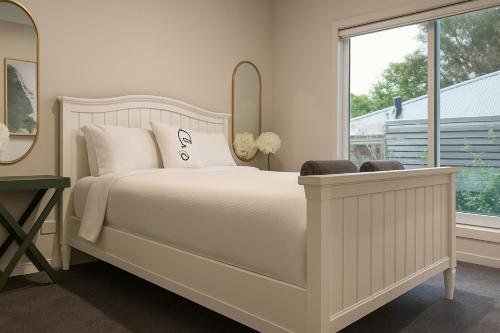 a bedroom with a white bed and a window at Yarra Valley Retreat - Kids, Wine, Outdoors in Healesville