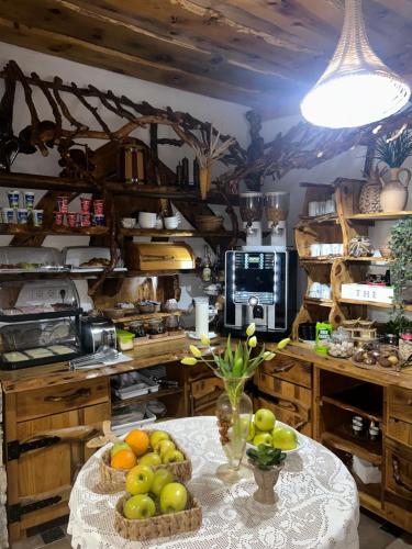 a kitchen with a table with fruit on it at Rustic Lodge Plitvice in Plitvička Jezera