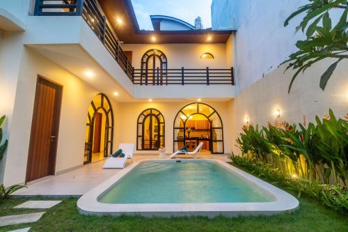 a swimming pool in the backyard of a house at Villa Amaia Canggu in Kerobokan