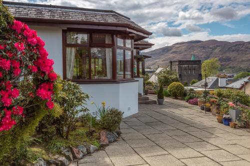 a house with flowers on the side of it at Guisachan Guesthouse in Fort William