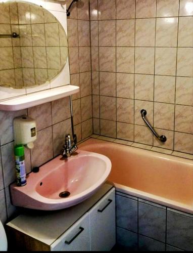 a bathroom with a sink and a bath tub at Luna Apartman501 in Siófok