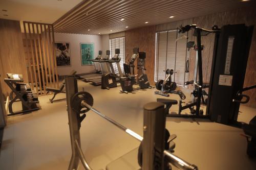 a gym with several treadmills and elliptical machines at Radisson Resort Hatgad Saputara in Saputara
