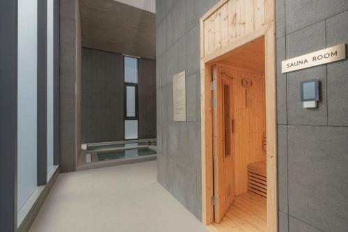 an entrance to a museum with a wooden door at Staybridge Suites Bangkok Sukhumvit by IHG in Bangkok