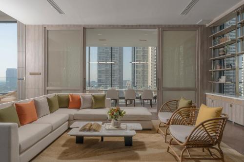 a living room with a couch and chairs at Staybridge Suites Bangkok Sukhumvit by IHG in Bangkok