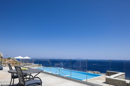 a view of the ocean from the balcony of a house at Seafront elegant villas, with infinity pools & devine views! in Agios Pavlos