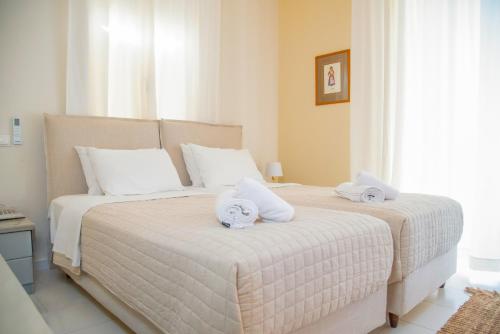 a bedroom with two beds with towels on them at Princess Hotel in Lassi