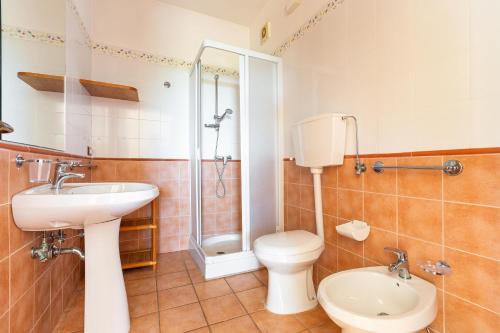 a bathroom with a toilet and a sink and a shower at Appartamento Messapia by BarbarHouse in Leuca