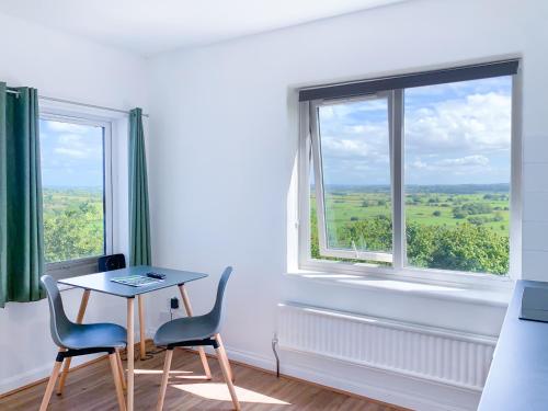 a room with a table and two chairs and a window at Glastonbury Studio - Tor View - Sleeps 2 in Glastonbury