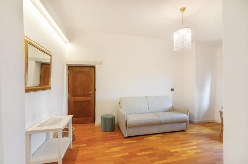 a living room with a chair and a table at Ospitalità La Rocca Chianti in Tavarnelle in Val di Pesa