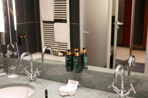 a bathroom counter with two sinks and a mirror at Schlosshotel Kitzbühel in Kitzbühel