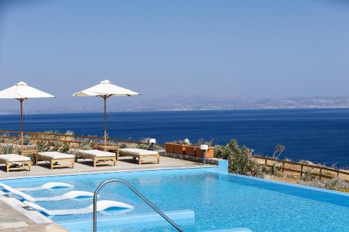 a swimming pool with a view of the ocean at Seafront elegant villas, with infinity pools & devine views! in Agios Pavlos