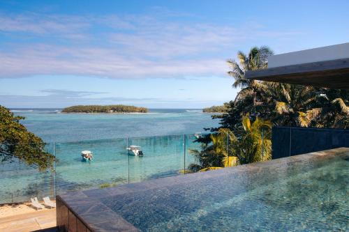 a swimming pool with a view of the ocean at Blue Nest Luxury Penthouse in Blue Bay
