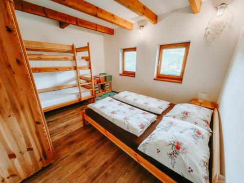 two beds in a room with a bunk bed at Wellness chata Medík in Súľov