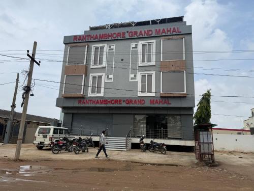 a man walking in front of a grand manual building at Ranthambhore Grand Mahal in Sawāi Mādhopur