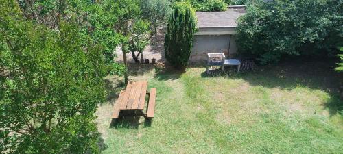 an overhead view of a wooden bench in a yard at MARIA HOLIDAY HOMES La Pineta di Sinalunga in Sinalunga