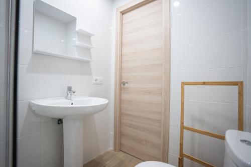 a white bathroom with a sink and a toilet at LETS HOLIDAYS Centric & Near the Sea Victoria apartment 3 in Tossa de Mar
