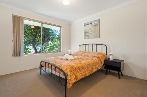 a bedroom with a bed and a window at SPACIOUS JANDAKOT HOUSE FOR FAMILY AND BUSINESs in Perth