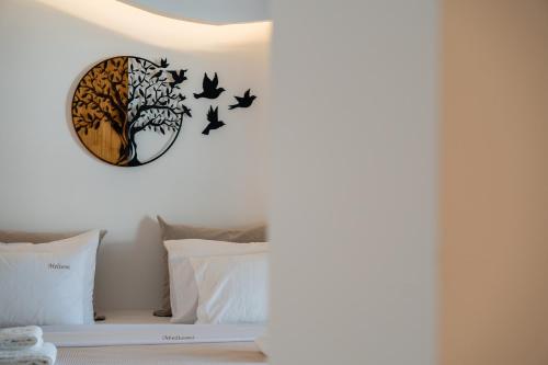 a bedroom with a bed with a clock on the wall at Meltemi Marmaras in Neos Marmaras