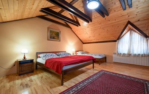a bedroom with a bed and a wooden ceiling at Villa Requiem by Villas Guide in Bednja