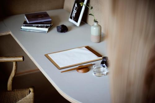 a white table with a mirror and books on it at SANU 2nd Home 軽井沢1st in Oiwake