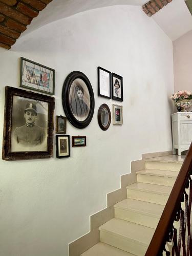 a stairway with pictures on the wall and a stair case at GABRY GUEST HOUSE in Bruno