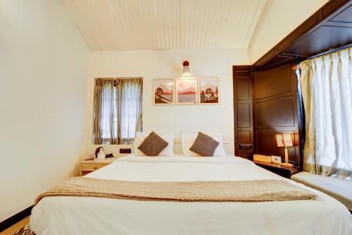 a bedroom with a large white bed in a room at Garden Haven 3 BHK Villa with Balcony and Verandah Escape in Kotagiri