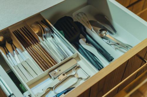a wooden drawer filled with utensils at SANU 2nd Home 軽井沢1st in Oiwake