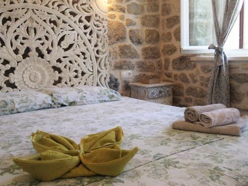 a bedroom with a large bed with towels on it at Apartments Jasmina in Korčula