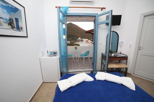 a room with a blue bed with two white pillows at Casaprimavera in Katapola