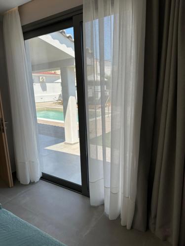 a sliding glass door with a view of a yard at Evdokia Suites in Gouves