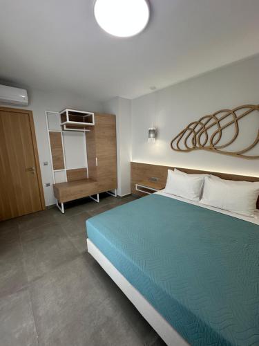 a bedroom with a bed and a room with a kitchen at Evdokia Suites in Gouves