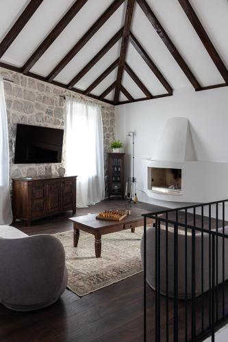 a living room with a table and a couch at Heritage house Stone Orchard, near Dubrovnik in Orasac