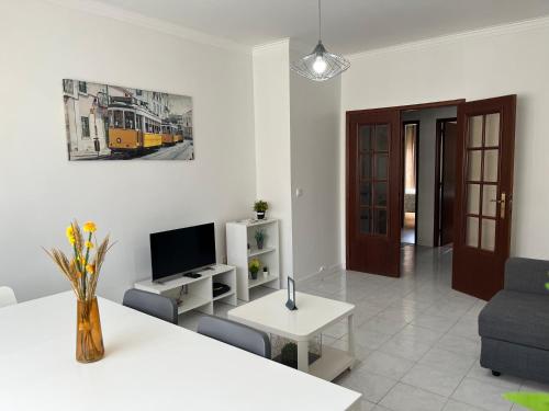 a living room with a couch and a tv at OFIR NATURE in Fão
