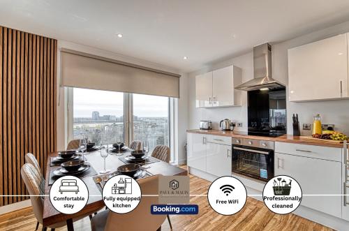 a kitchen and dining room with a table and appliances at 3 Bedroom Apartment By Paul & Malin Properties Short Lets & Serviced Accommodation Stretford With Gym Access in Manchester