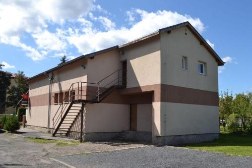 a building with a staircase on the side of it at Penzion u Hada in Chomutov