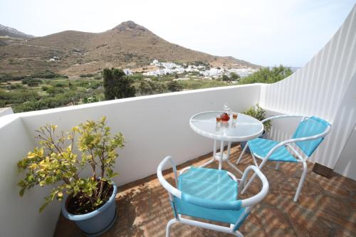 a balcony with a glass table and two chairs at Casaprimavera in Katapola