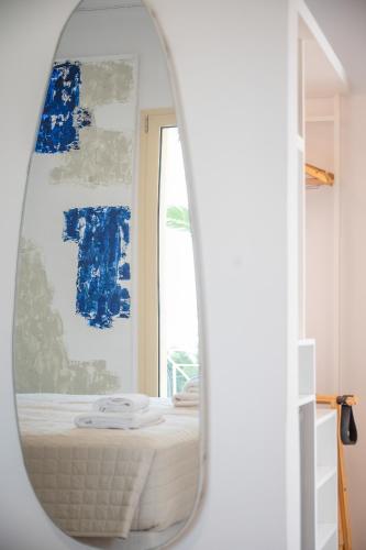 a mirror in a room with a bed and a window at Princess Hotel in Lassi