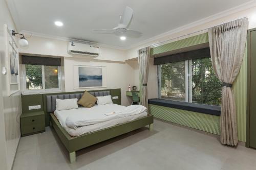 a bedroom with a bed and a window at Apple Tree Apartments Koregaon Park in Pune