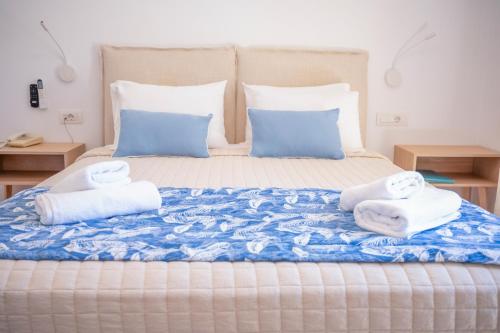 a bedroom with a bed with towels on it at Princess Hotel in Lassi
