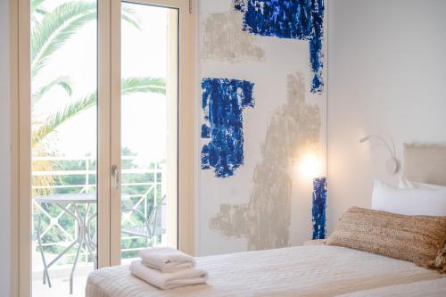 a bedroom with a bed with towels on it at Princess Hotel in Lassi