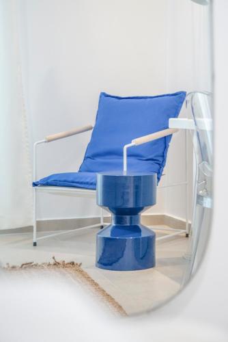 a hospital bed with a blue chair in a mirror at Princess Hotel in Lassi