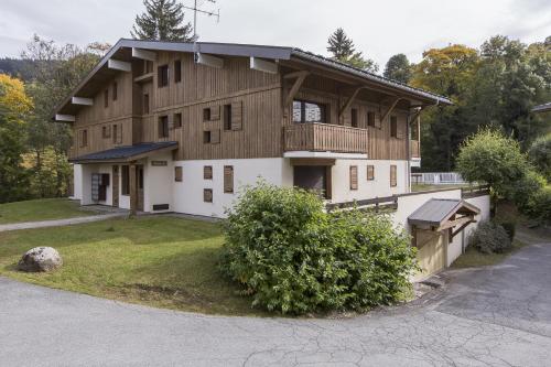 a large house with a gambrel roof at Les Chalets Autrichiens - Megève in Megève