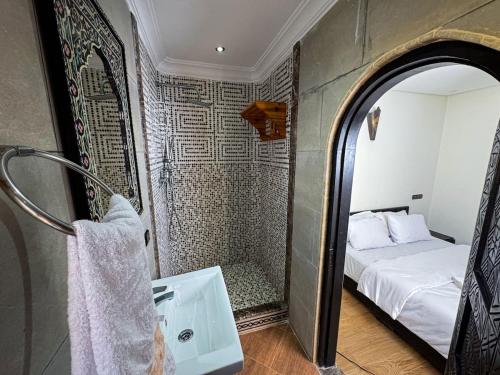 a bathroom with a bed and a mirror and a sink at Seaside Cozy Mini Villa Stay in Id Taleb