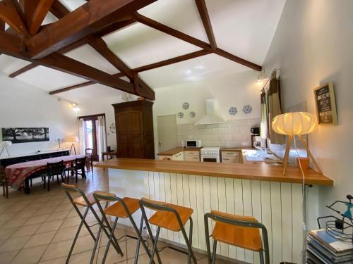 une cuisine et une salle à manger avec une table et des chaises dans l'établissement Villa Moutiques, à Cazaubon