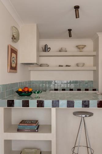 a kitchen with a counter with a bowl of fruit at Spacious, ocean-front, pied-à-terre with stunning views &opposite cafes in Perth