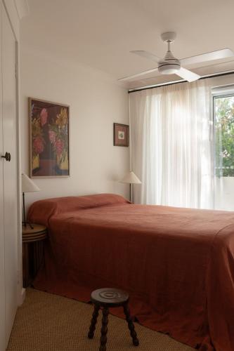 a bedroom with a red bed and a window at Spacious, ocean-front, pied-à-terre with stunning views &opposite cafes in Perth