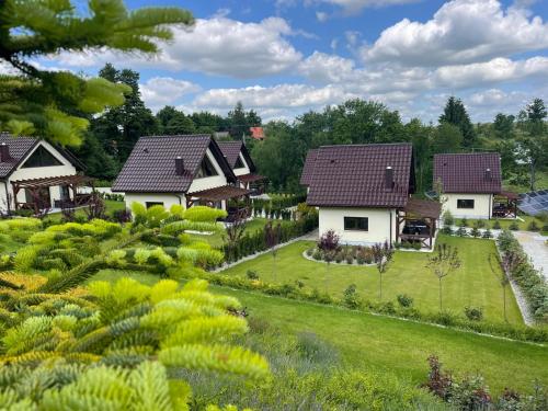 a row of houses in a garden at Osada Prado in Michałkowa